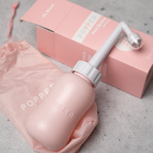 Load image into Gallery viewer, Postpartum peri bottle sits on packaging