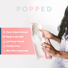 Load image into Gallery viewer, Woman pumps witch hazel foam on pad. Infographic says the foam is made in the USA and new-mom approved