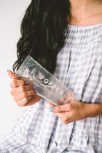 Load image into Gallery viewer, A woman holding one hot and cold pack with clear, eco-friendly gel inside. The product is labeled with the brand name Popped.
