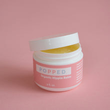 Load image into Gallery viewer, Jar of Popped Organic Nipple Balm is showing with lid partially screwed on. The contents inside appear yellow.
