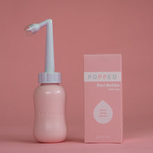 Load image into Gallery viewer, A pink bottle with a long white angled nozzle (with cap) at the top is pictured next to the packaging, which reads, &quot;Popped Peri Bottle (with bag), 300ml&quot;.
