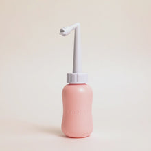 Load and play video in Gallery viewer, Video of a woman&#39;s hands holding the peri bottle and demonstrated how the nozzle is adjustable in length. Shows you can make it shorter or longer depending on your needs.
