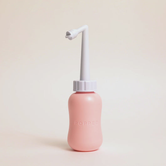 Video of a woman's hands holding the peri bottle and demonstrated how the nozzle is adjustable in length. Shows you can make it shorter or longer depending on your needs.