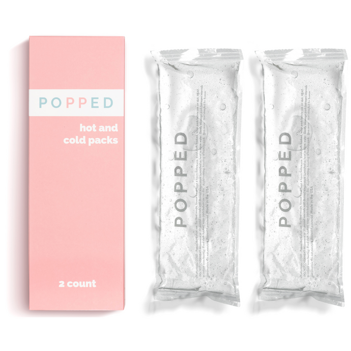2 Popped reusable hot and cols packs are next to the pink packaging and on a white background