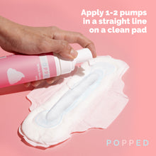 Load image into Gallery viewer, Woman pumps witch hazel foam onto a pad. Directions stateL Apply 1-2 pumps in a straight line on a clean pad.
